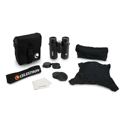 Celestron binoculars set with carrying case, lens cleaning cloth, and accessories on a white background